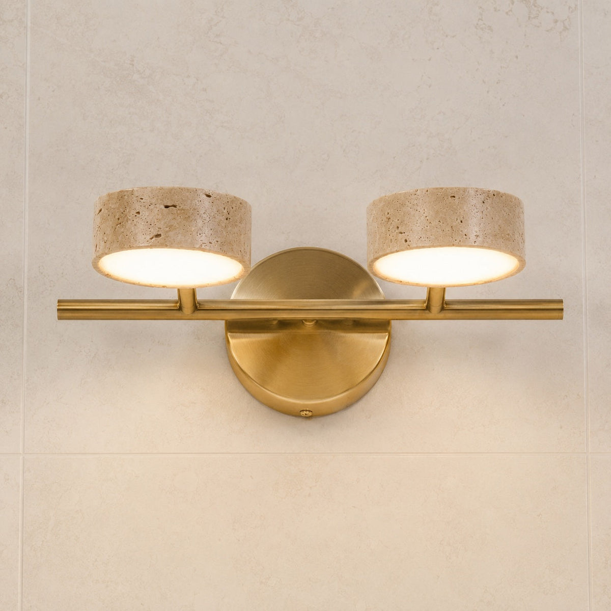 Brass twin wall sconce with travertine shades
